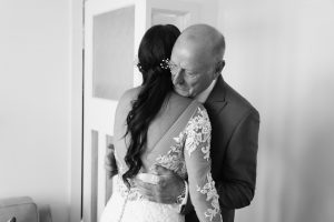 father hugs is daughter at her wedding