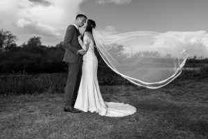bride and groom portrait with flowing veil