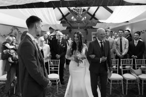 dad walks his daughter up the aisle