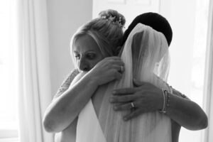 mum hugs her daughter before her wedding
