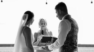 friend conducts ceremony at garden wedding