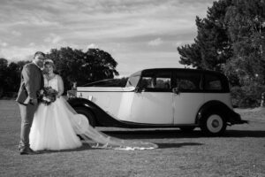 bride and groom with vintage car at Woodland waters