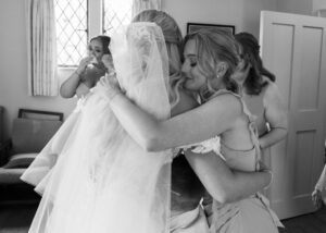 bridesmaids hug bride at doddington hall