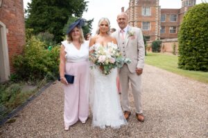 bride with parents at doddington hall