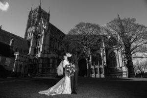 bride and groom kissing with Lincoln cathedral in background
