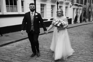 bride and groom walking through Bailgate in Lincoln