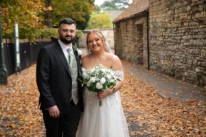 Bride and groom with autumnal leaves