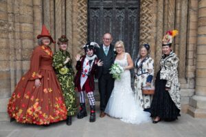 bride and groom at Lincoln cathedral on steam punk day