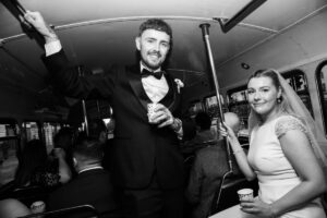 bride and groom enjoying routemaster bus