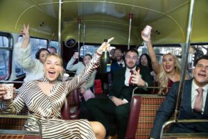 wedding guests on London bus