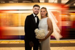 bride and groom with tube train behind