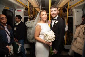bride and groom on tube train